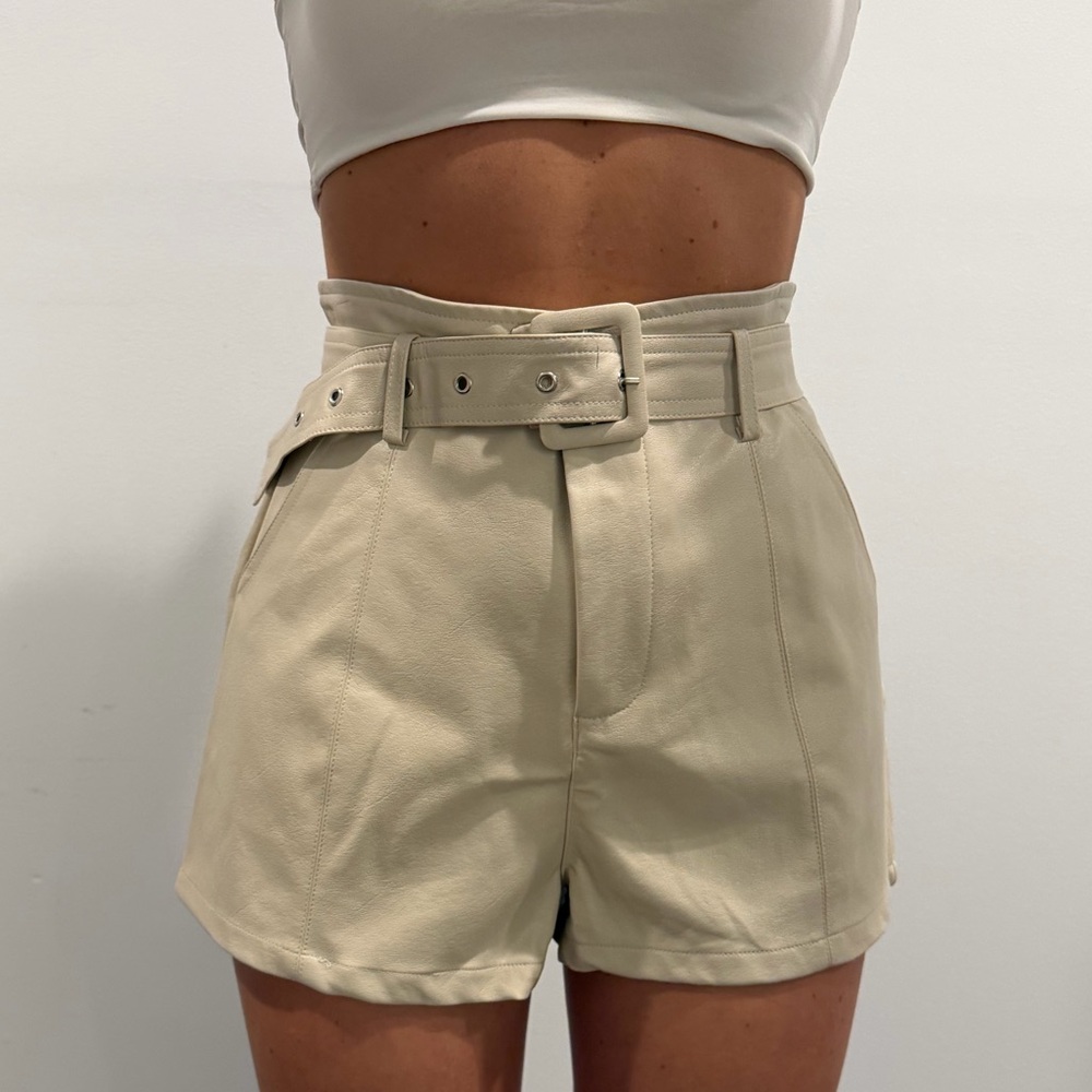 Nude leather shorts with belt.